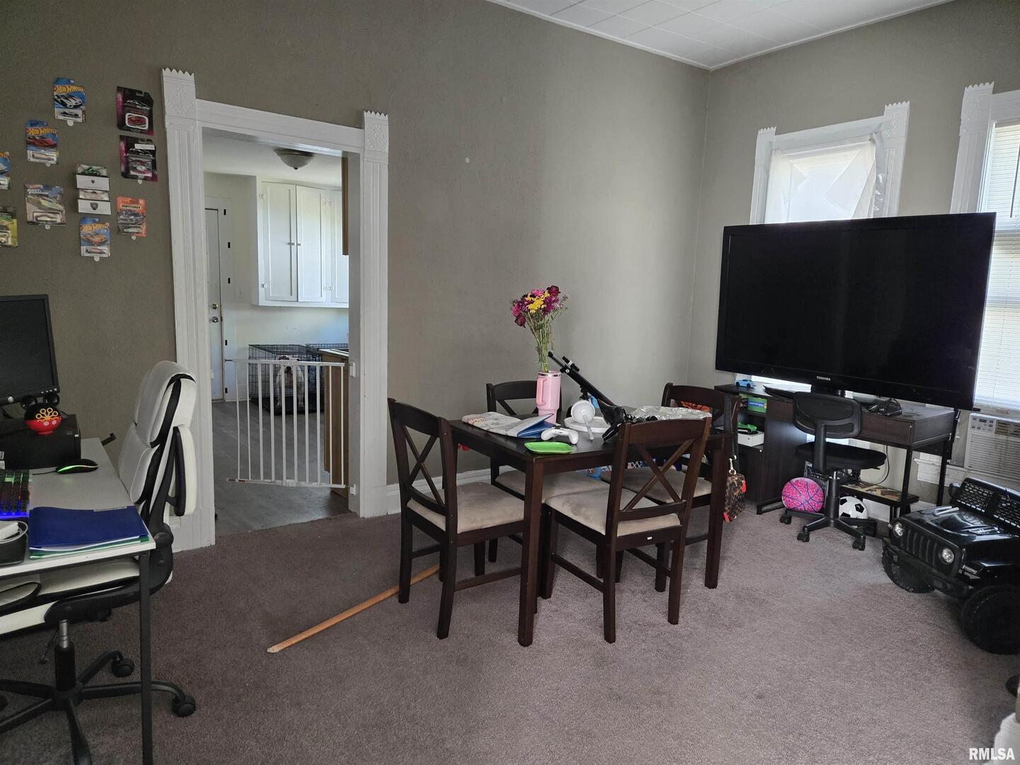 408 North Springer Street, Unit 2 Carbondale, IL 62901 - Photo 6 of 15 a livingroom with dining area a flat screen tv and a window