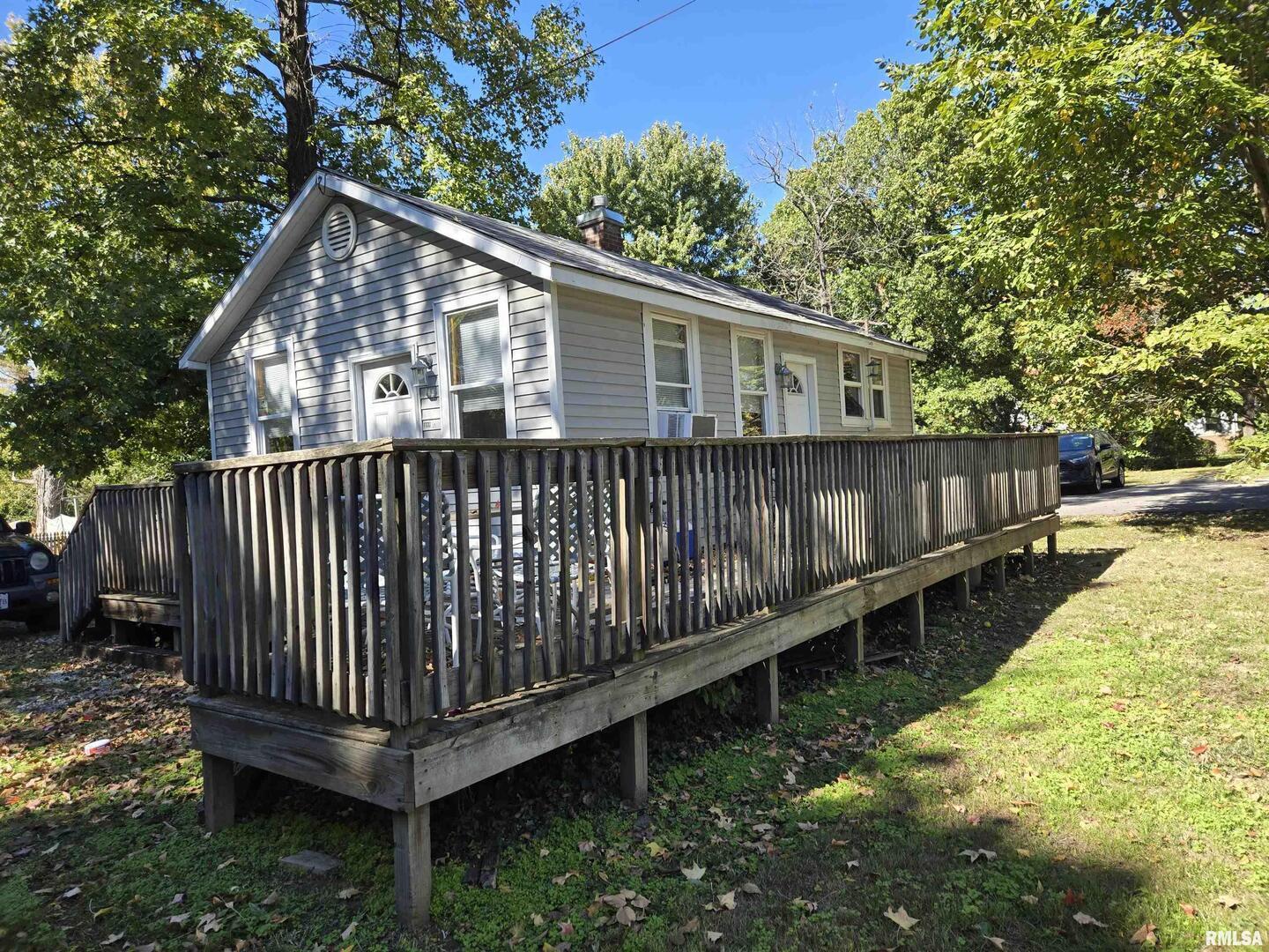 408 North Springer Street, Unit 2 Carbondale, IL 62901 - Photo 10 of 15 a view of a house with a small yard and wooden deck