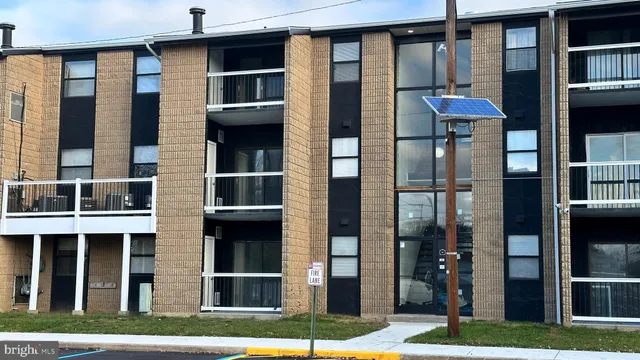 a front view of building with a garden