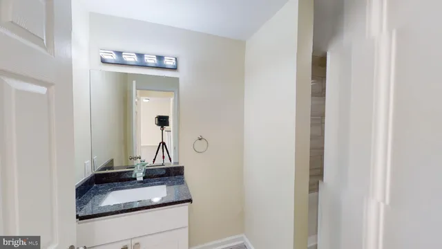 a bathroom with sink and mirror