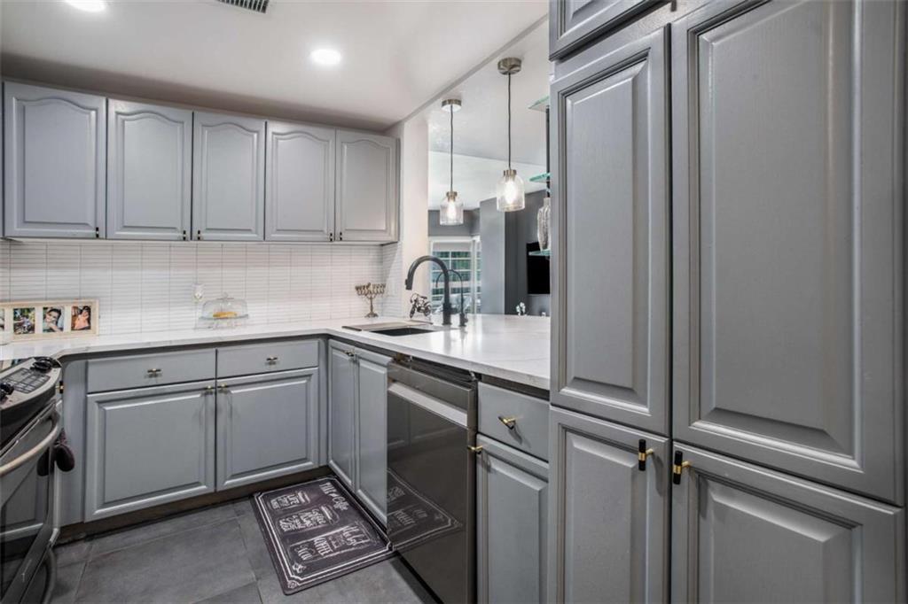 3475 Oak Valley Road Northeast, Unit 1630 Atlanta, GA 30326 - Photo 16 of 38 a kitchen with a sink stainless steel appliances and cabinets