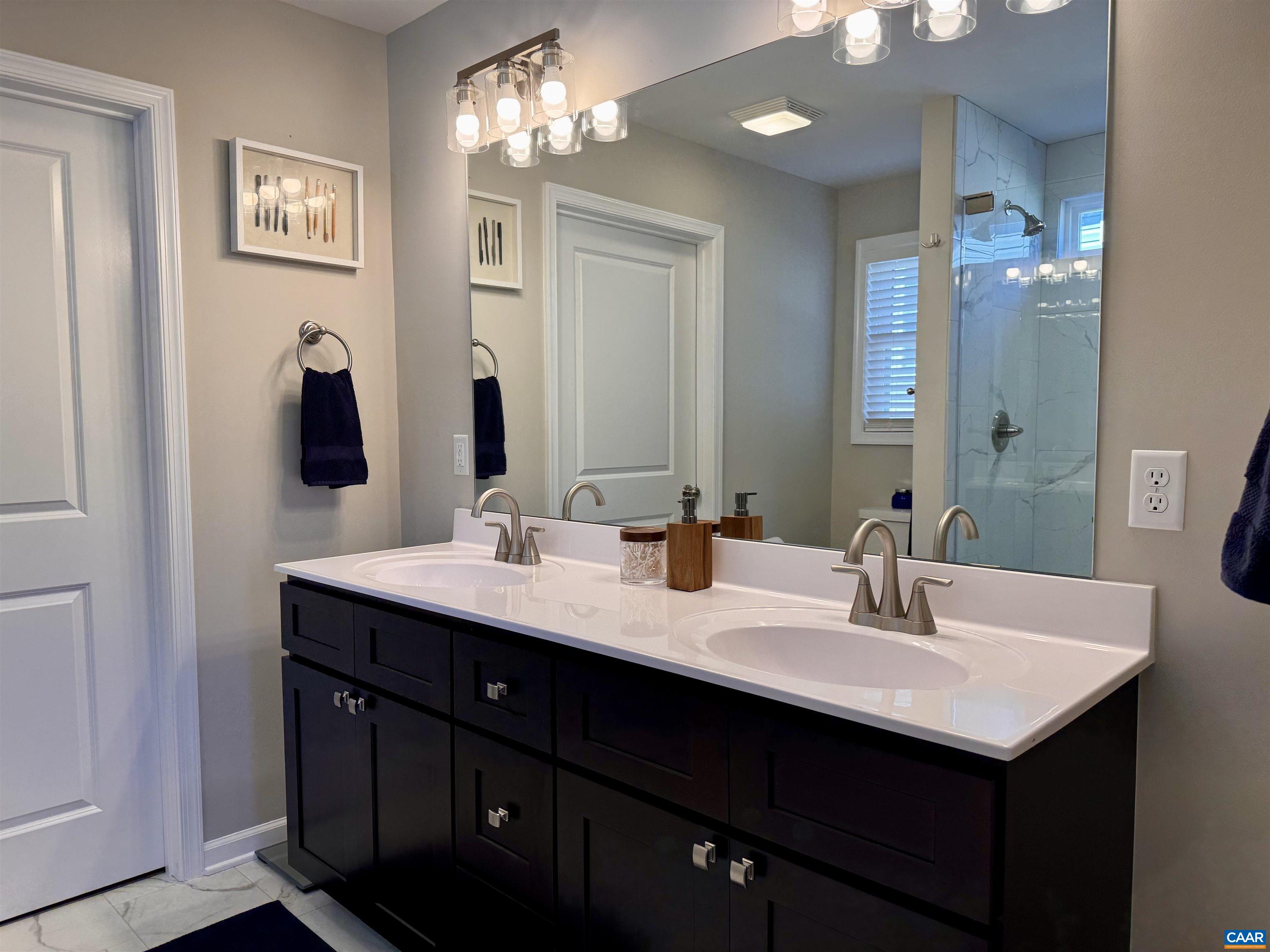 201 Spring Run Lane Waynesboro, VA 22980 - Photo 18 of 29 a bathroom with double vanity sinks a vanity a lamp and a mirror