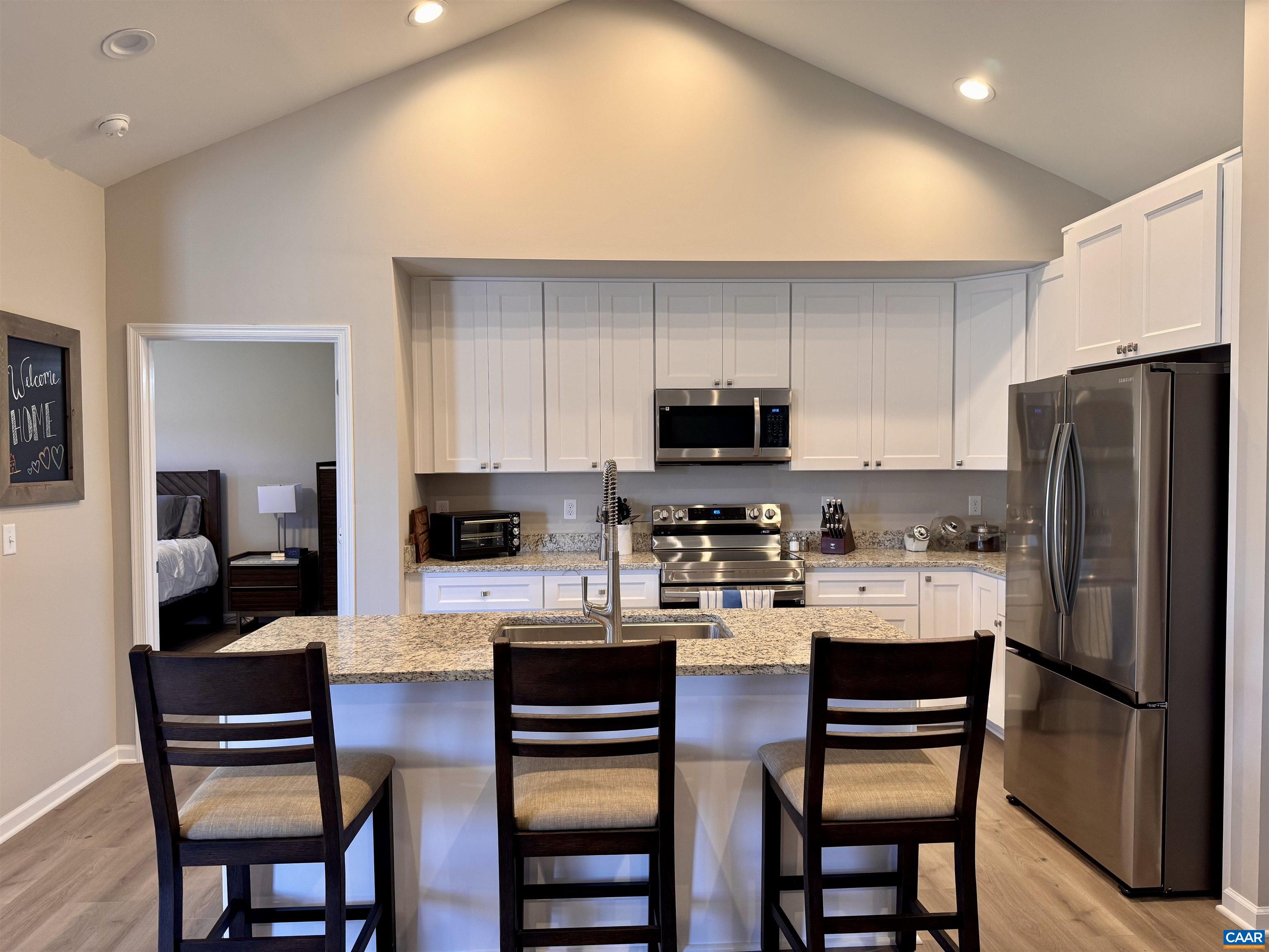 201 Spring Run Lane Waynesboro, VA 22980 - Photo 8 of 29 a kitchen with a dining table chairs refrigerator and microwave