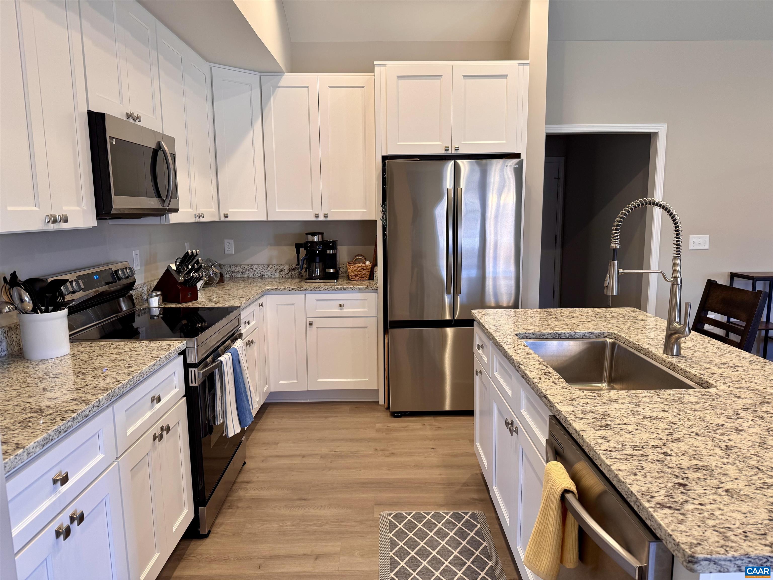 201 Spring Run Lane Waynesboro, VA 22980 - Photo 9 of 29 a kitchen with granite countertop a sink dishwasher stove and refrigerator with wooden cabinets