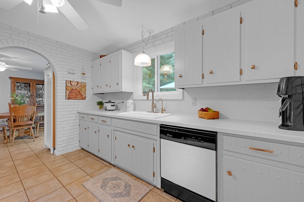 47 Horseshoe Circle Ware, MA 01082 - Photo 12 of 37 a kitchen with granite countertop white cabinets stainless steel appliances and a window