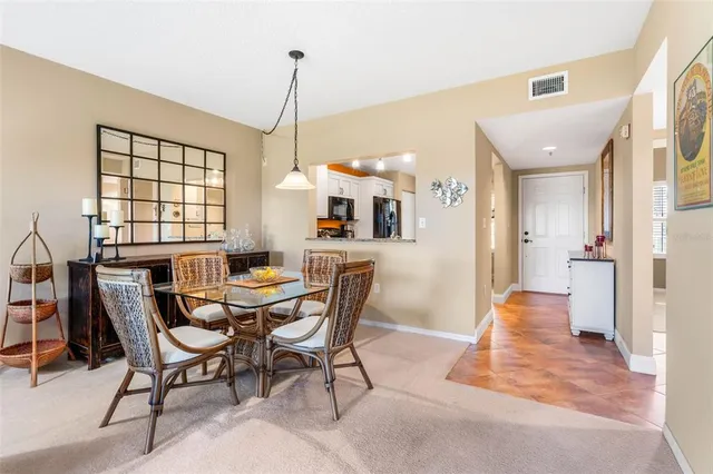 a view of a dining room with furniture wooden floor and a chandelier