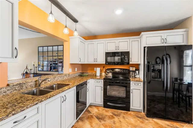 a kitchen with a sink stove and refrigerator