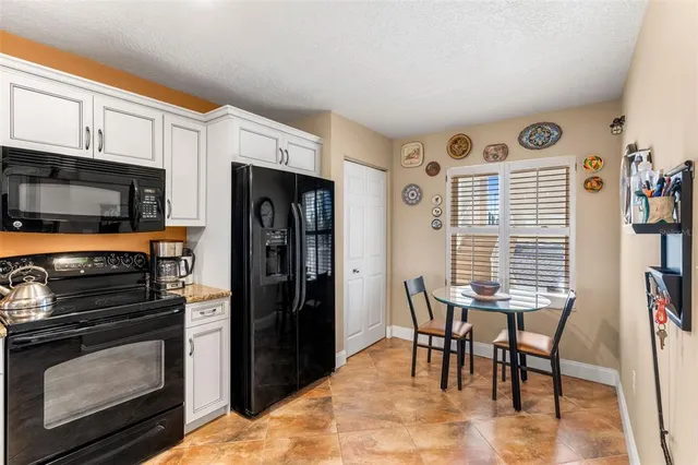 a kitchen with stainless steel appliances granite countertop a stove microwave and a refrigerator