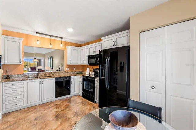 a kitchen with stainless steel appliances a sink cabinets and a refrigerator