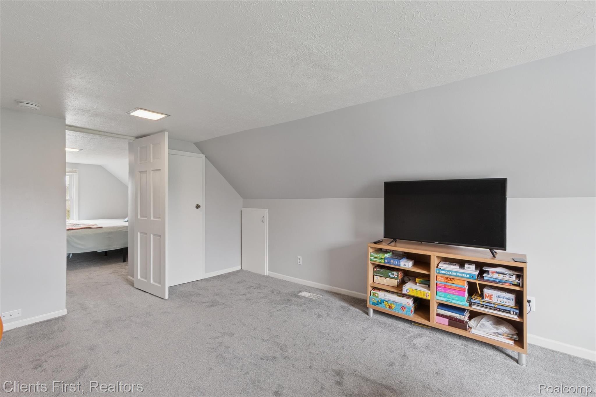 6550 Hitchingham Road Ypsilanti, MI 48197 - Photo 27 of 53 Bonus room with a textured ceiling, carpet flooring, and lofted ceiling