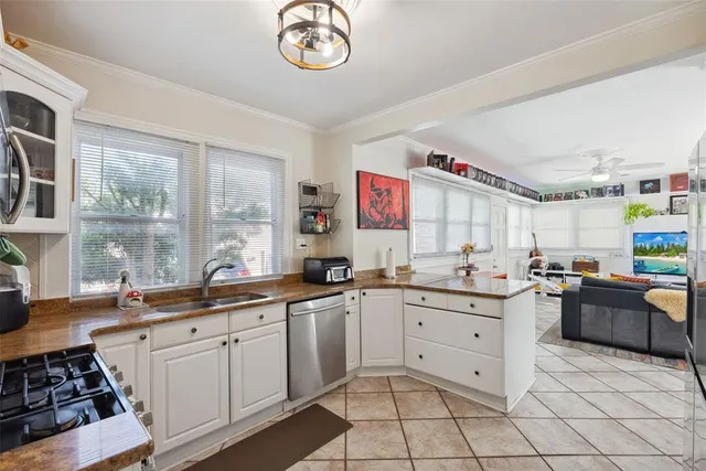 a kitchen with stainless steel appliances granite countertop a sink and cabinets