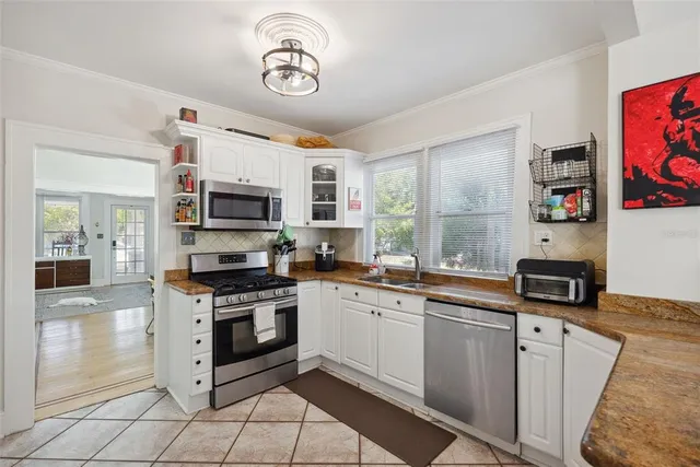 a kitchen with a refrigerator and cabinets