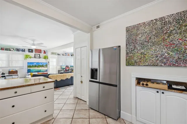 a living room with furniture a flat screen tv and a floor to ceiling window