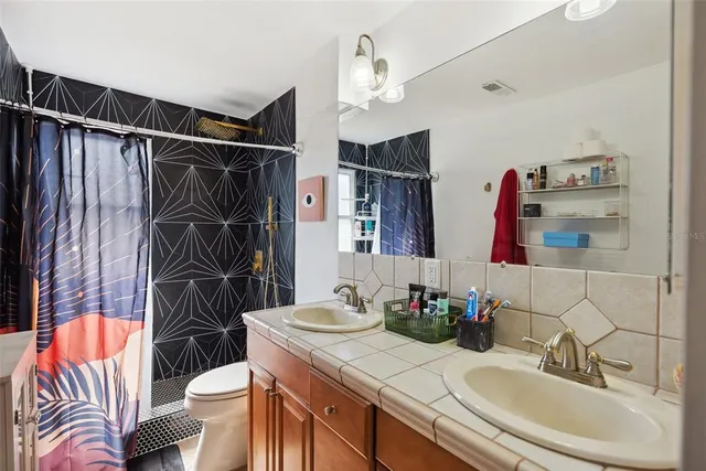 a bedroom with bed and wooden floor