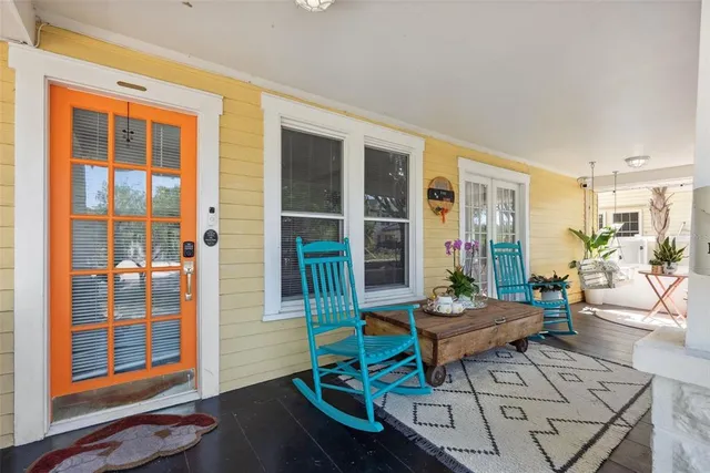 a view of a living room with furniture and floor to ceiling windows