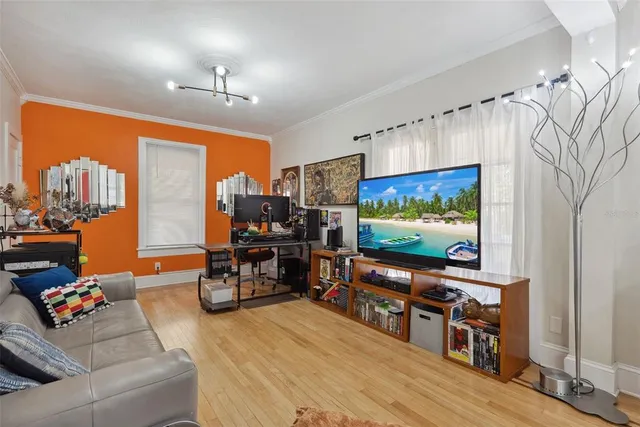 a living room with furniture and a flat screen tv