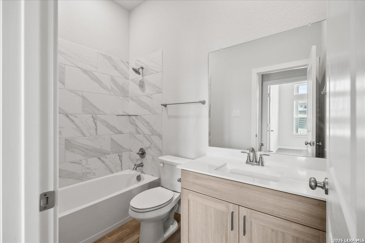 142 Stream Street Seguin, TX 78155 - Photo 14 of 20 a bathroom with a sink a toilet and shower