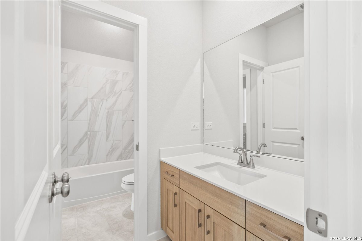 142 Stream Street Seguin, TX 78155 - Photo 15 of 20 a bathroom with a sink a toilet and shower