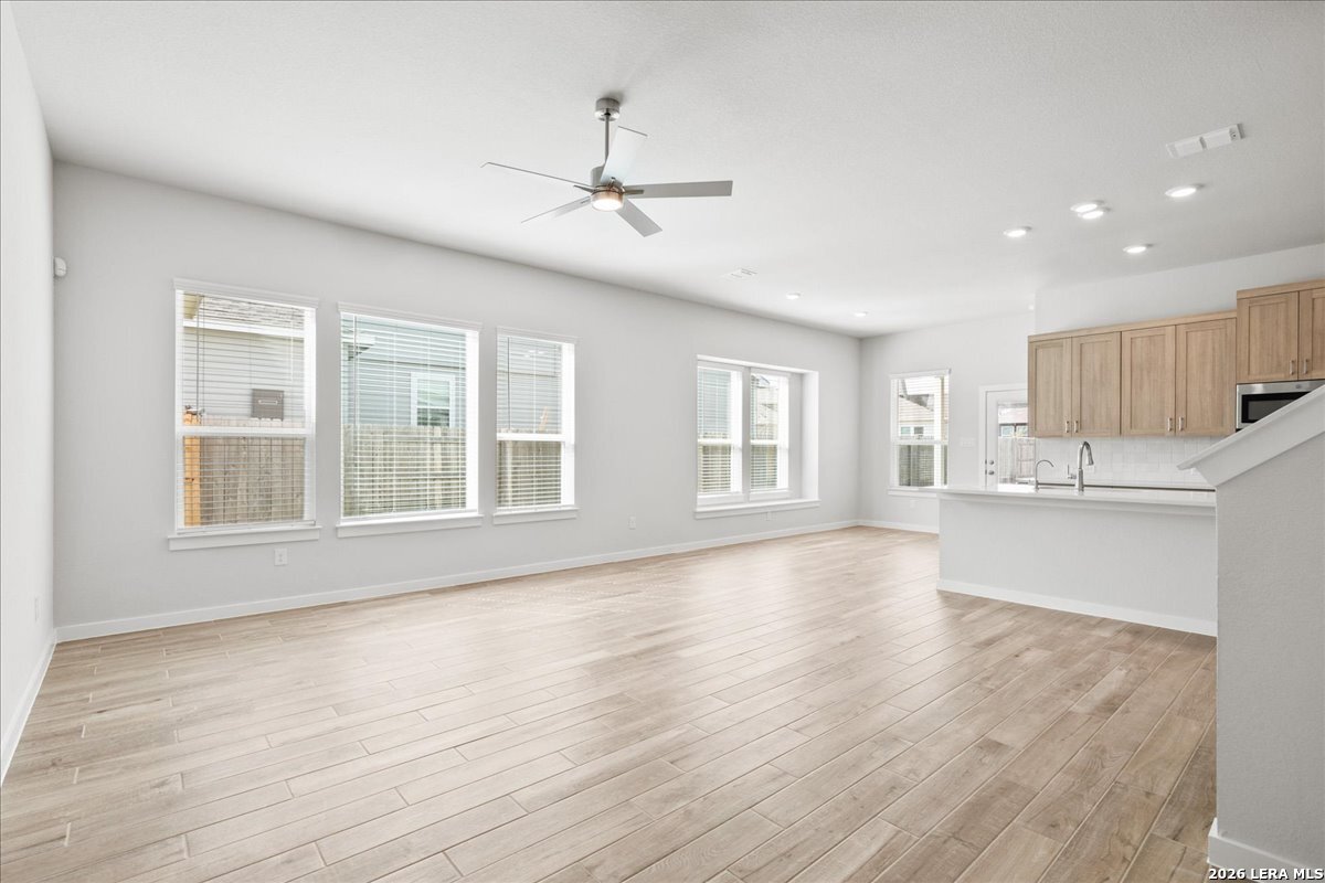 142 Stream Street Seguin, TX 78155 - Photo 2 of 20 a view of an empty room with a window and wooden floor