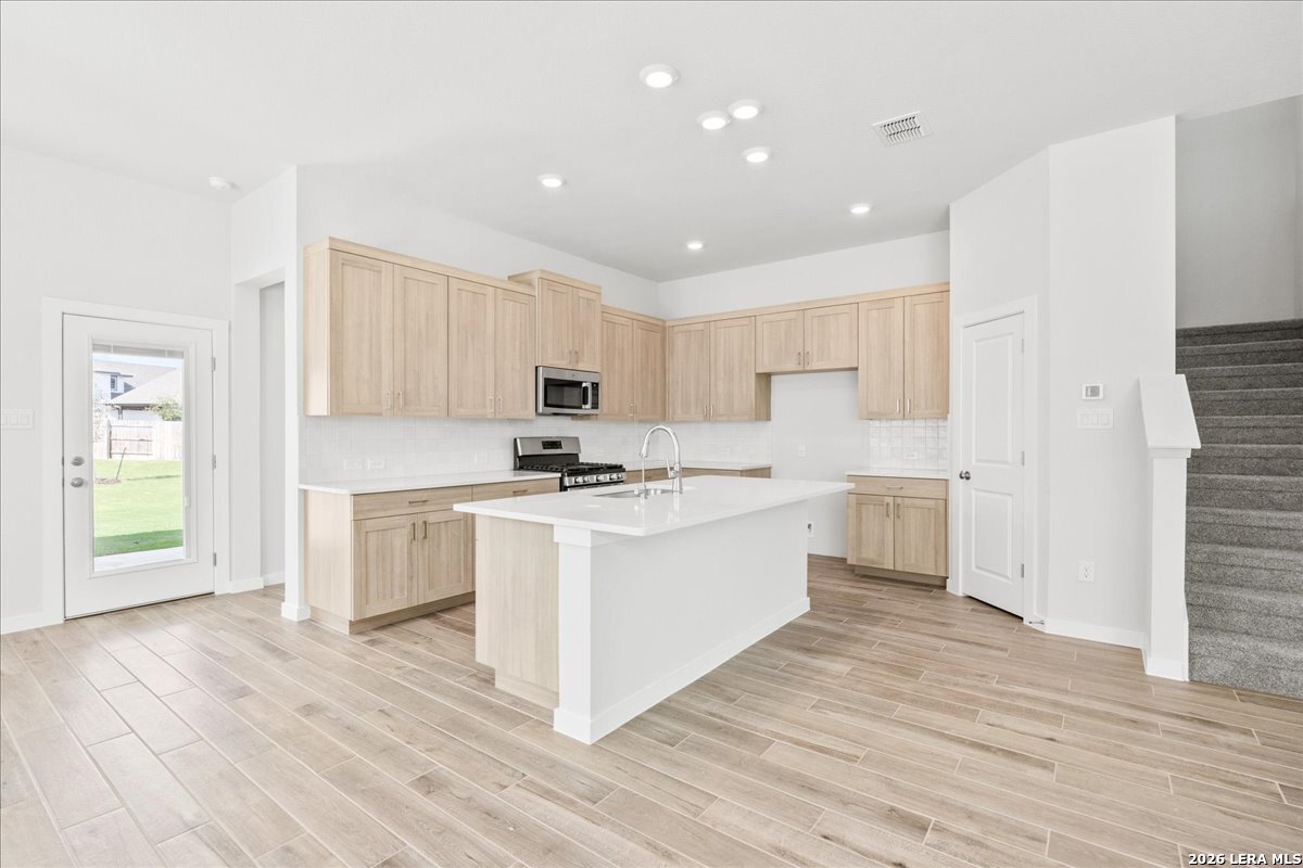 142 Stream Street Seguin, TX 78155 - Photo 7 of 20 a kitchen with white cabinets and white appliances