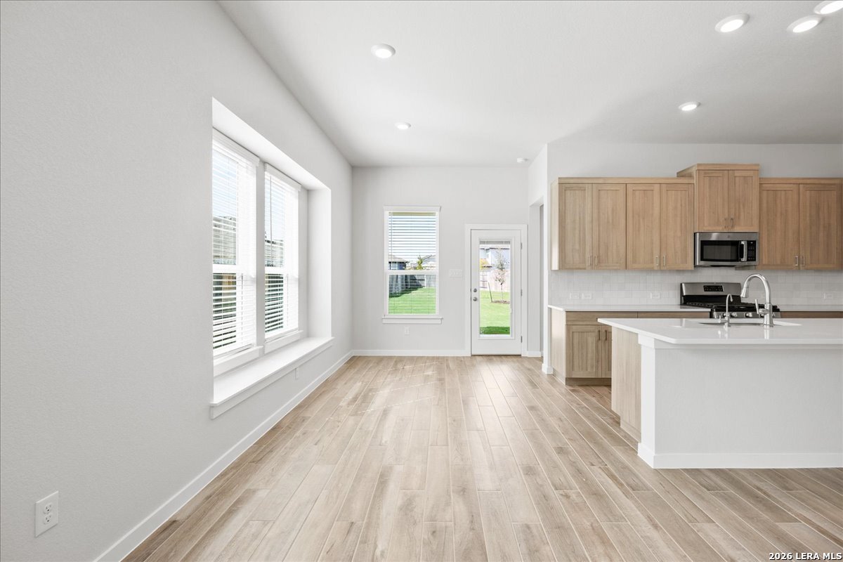 142 Stream Street Seguin, TX 78155 - Photo 8 of 20 a view of a kitchen with microwave and stove top oven