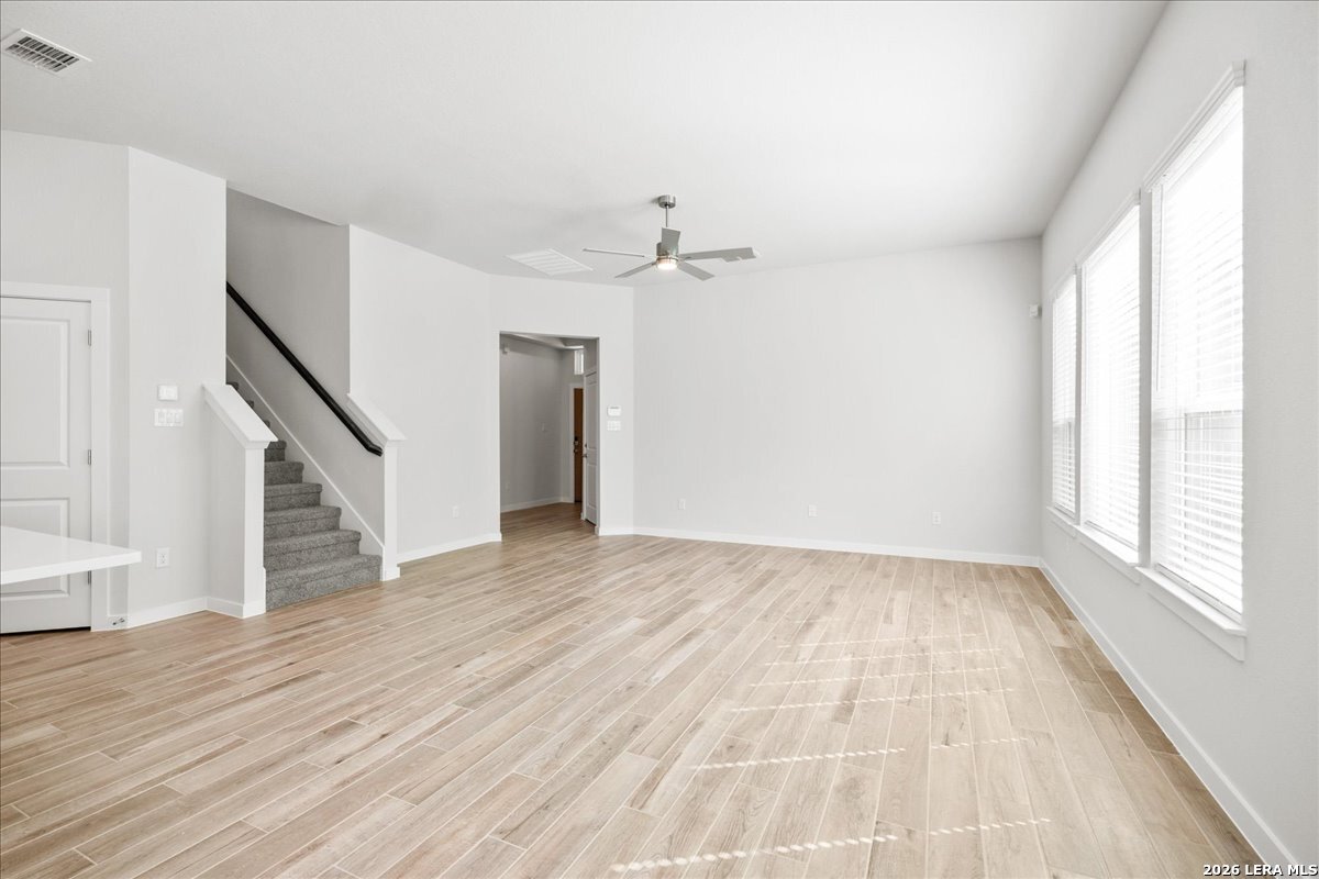 142 Stream Street Seguin, TX 78155 - Photo 9 of 20 a view of an empty room with wooden floor and a window