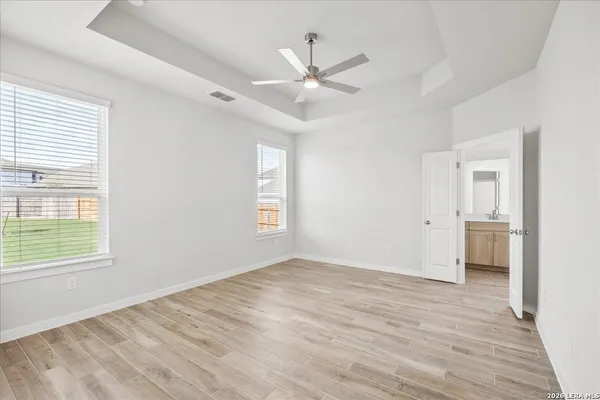 a spacious bathroom with a double vanity sink a mirror and a