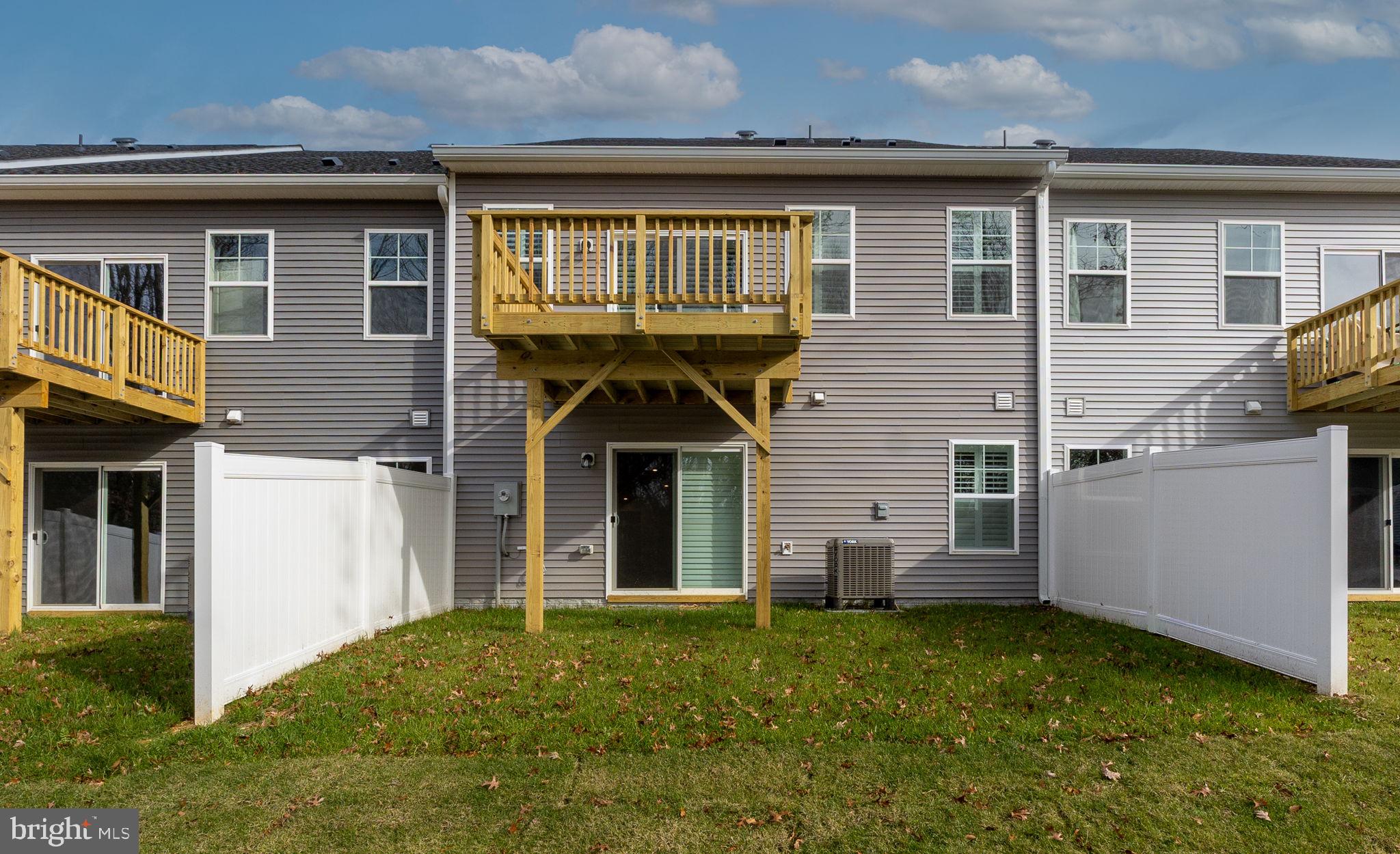 10628 Afton Grove Court Fredericksburg, VA 22408 - Photo 5 of 5 a view of a house with many windows and a yard