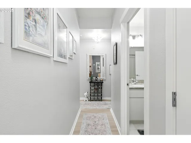 a bedroom with a bed and a flat tv screen on dresser