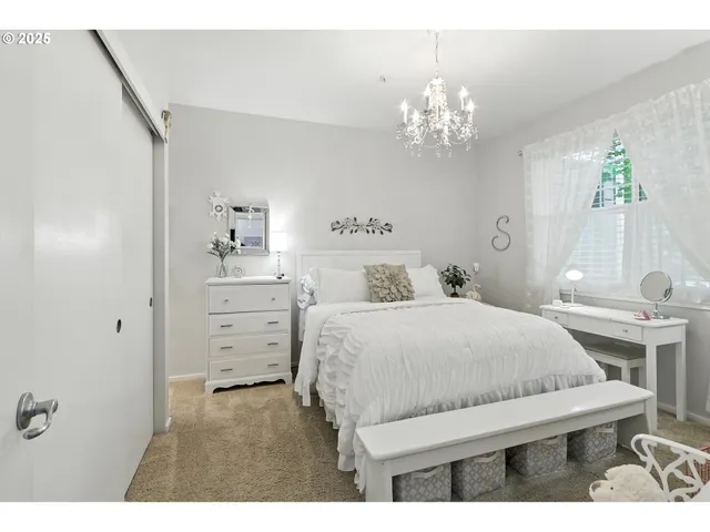 a bedroom with a bed and a flat tv screen on the dresser