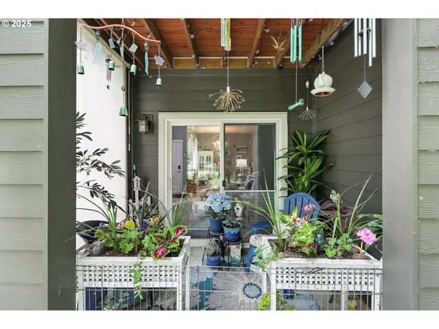 a living room with furniture a chandelier and a dining table