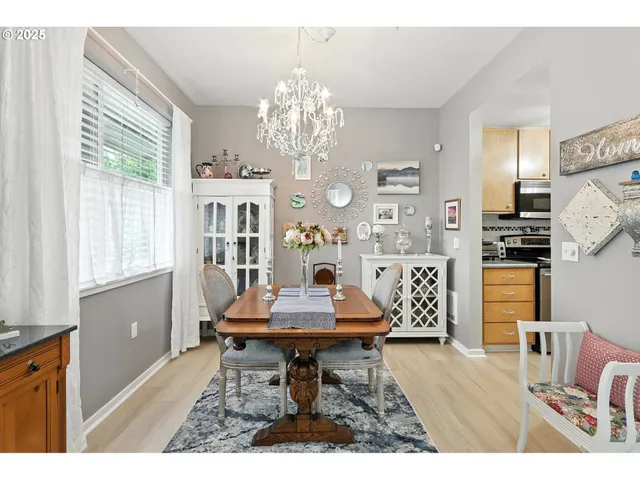 a living room with furniture a chandelier and a dining table
