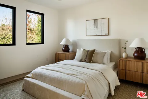 a bedroom with bed and window