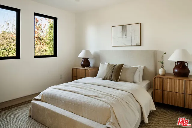 a bedroom with bed and window