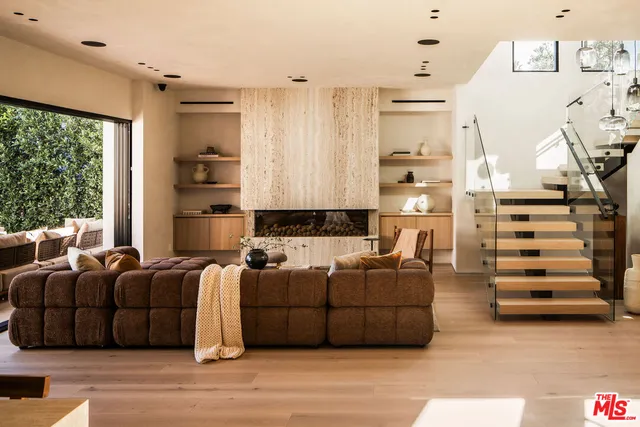 a living room with furniture window and wooden floor