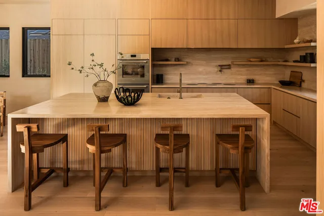 a kitchen with a table chairs and microwave