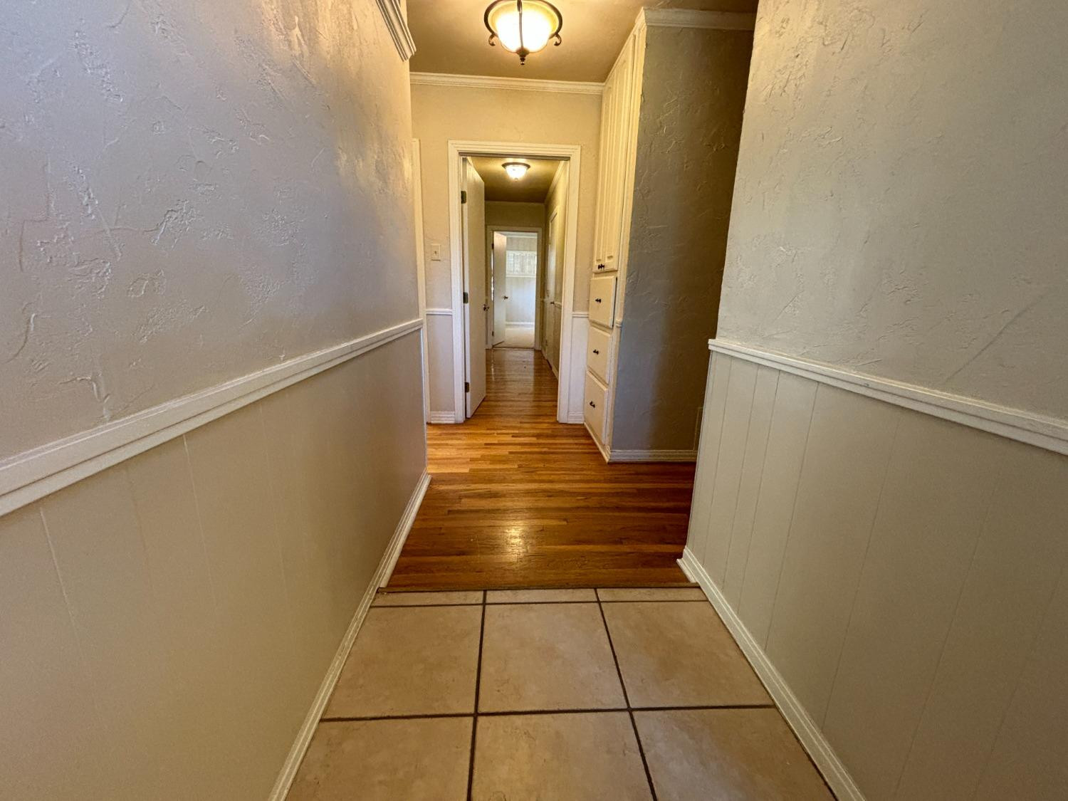 2825 24th Street Lubbock, TX 79410 - Photo 3 of 16 a view of a hallway with wooden floor and a hallway