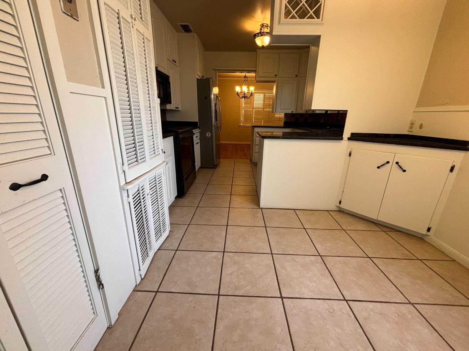 2825 24th Street Lubbock, TX 79410 - Photo 7 of 16 a view of a kitchen with utility cabinets