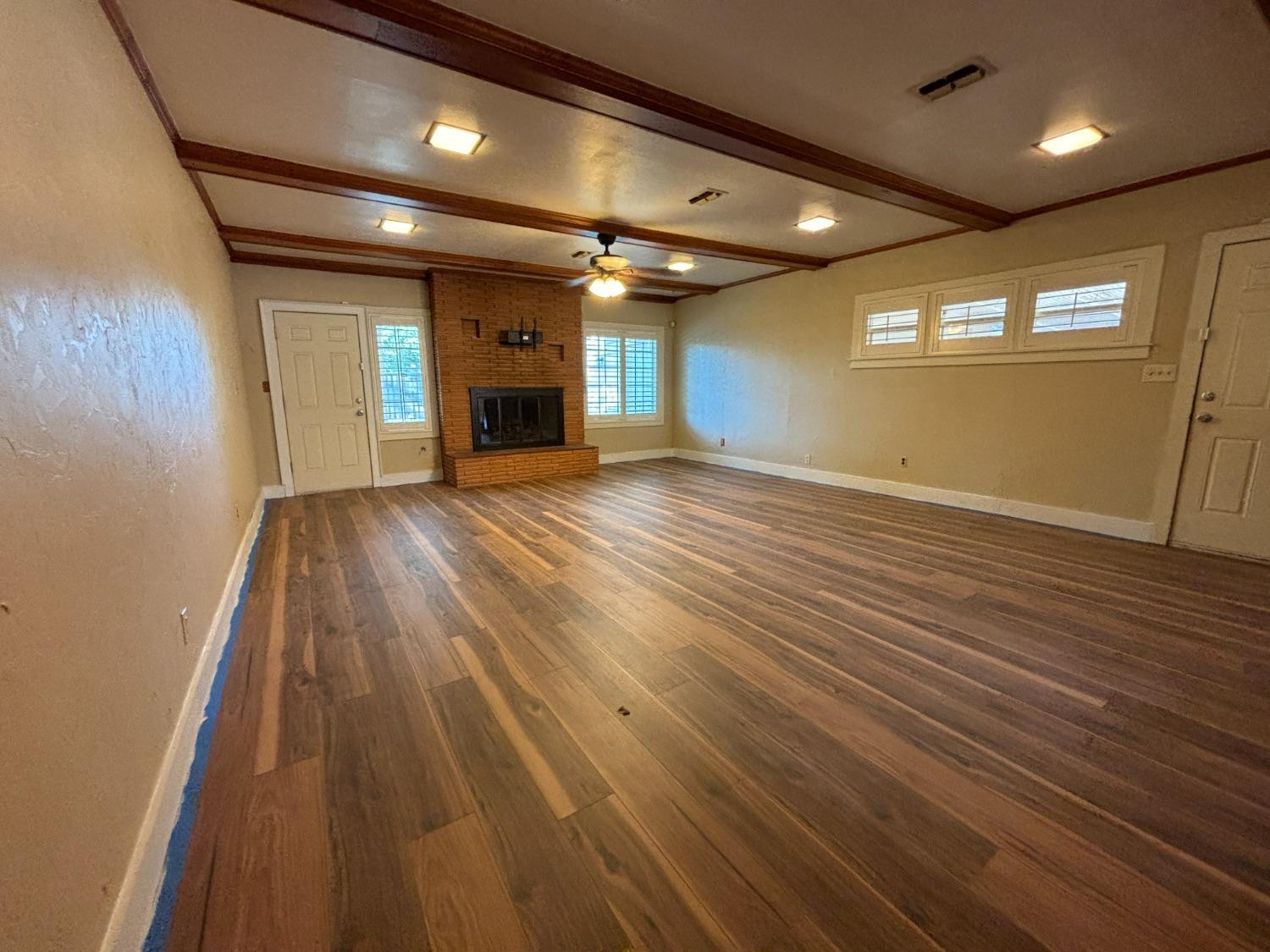 2825 24th Street Lubbock, TX 79410 - Photo 8 of 16 an empty room with wooden floor and windows