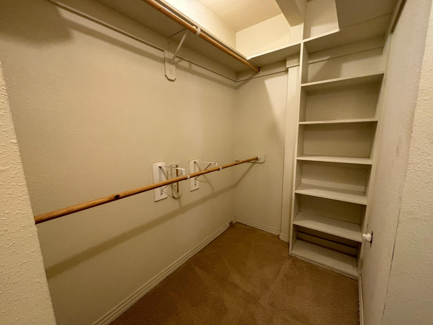 2825 24th Street Lubbock, TX 79410 - Photo 10 of 16 a view of walk in closet with empty racks