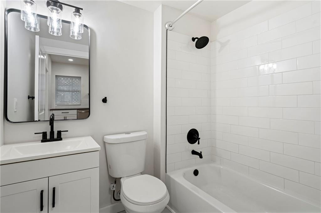 5140 Butler Street Pittsburgh, PA 15201 - Photo 8 of 25 a bathroom with a bathtub shower sink vanity and toilet