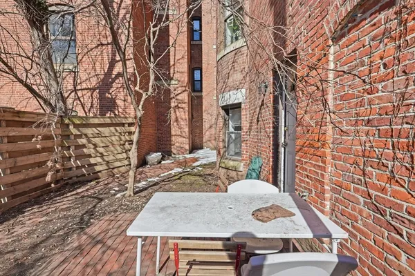 a view of a patio with chair and wooden floor