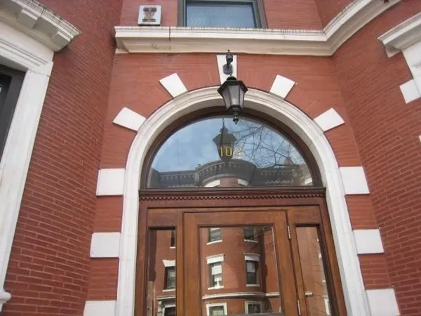 a view of a brick house with a large windows