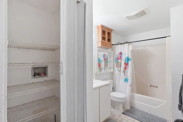 a white toilet sitting next to a bathroom sink