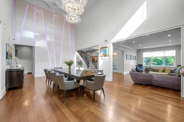 a dining room with furniture a chandelier and wooden floor