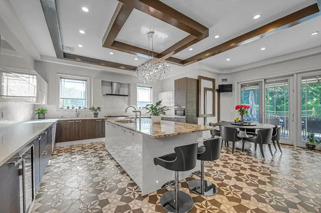 a kitchen with stainless steel appliances kitchen island granite countertop a table and chairs in it