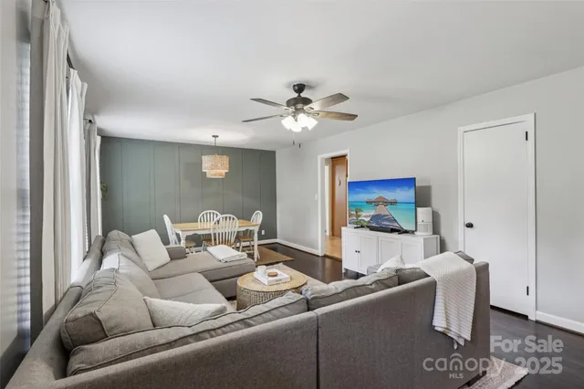 a living room with furniture and a ceiling fan