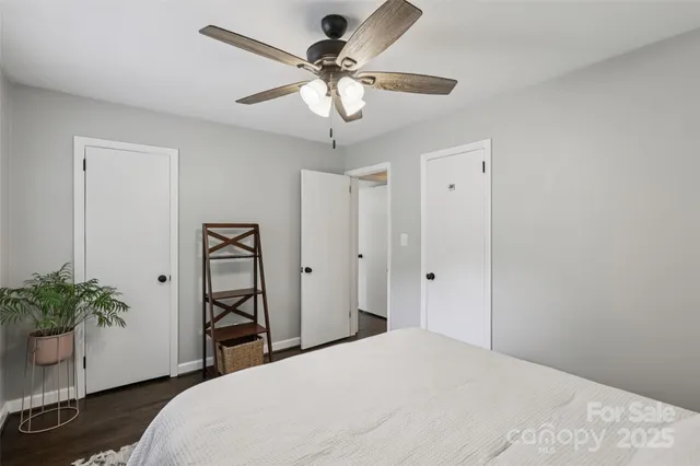 a bedroom with a bed and a potted plant