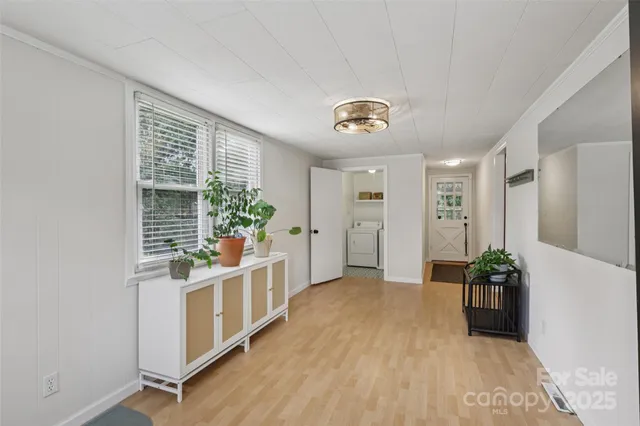 a view of a big room with wooden floor and windows