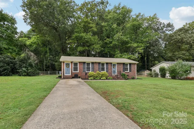 a front view of a house with yard patio and green space